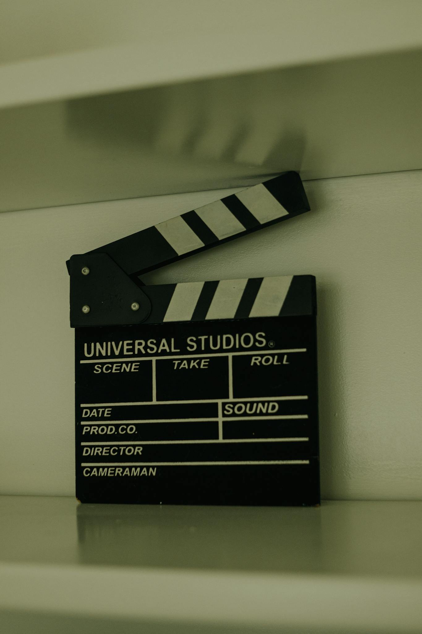 Close-up of a classic Universal Studios clapperboard on a shelf.